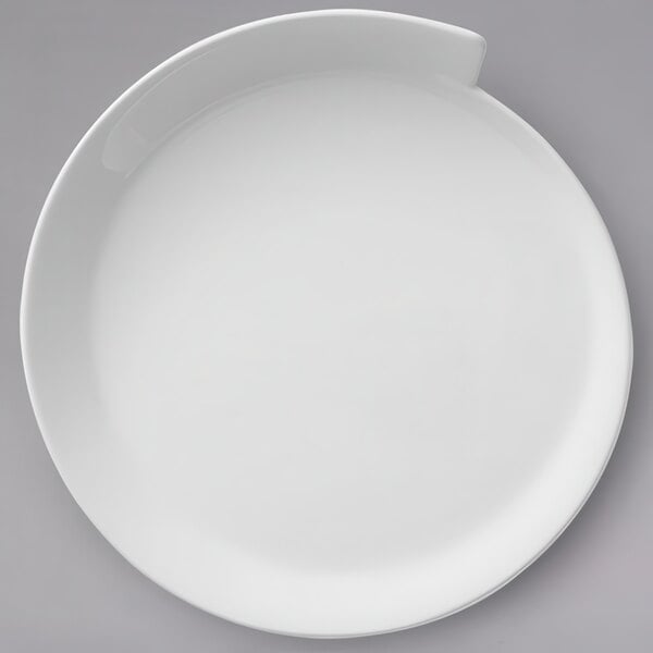 A Villeroy & Boch white porcelain plate with a curved edge.