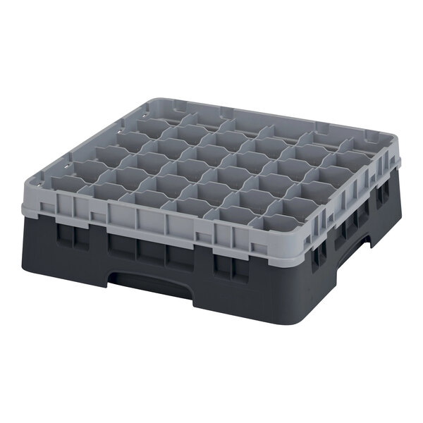 A black plastic Cambro glass rack with many small compartments.