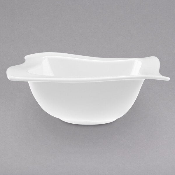 A white Villeroy & Boch NewWave bowl with a curved edge.