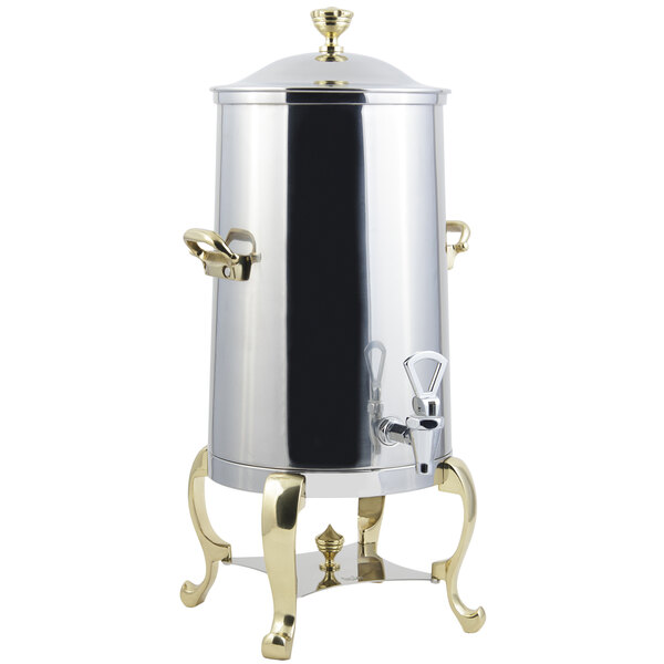 A stainless steel coffee chafer urn with brass trim.