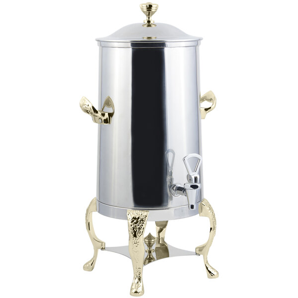 A stainless steel coffee chafer urn with brass trim.