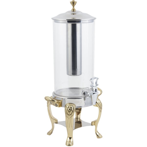 A Bon Chef brass beverage dispenser with a stainless steel ice chamber.