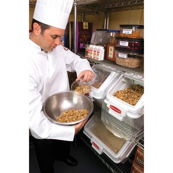 A chef pouring food from a Rubbermaid ProSave ingredient bin into a bowl.