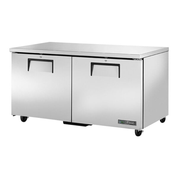 A silver True low profile undercounter freezer on wheels.