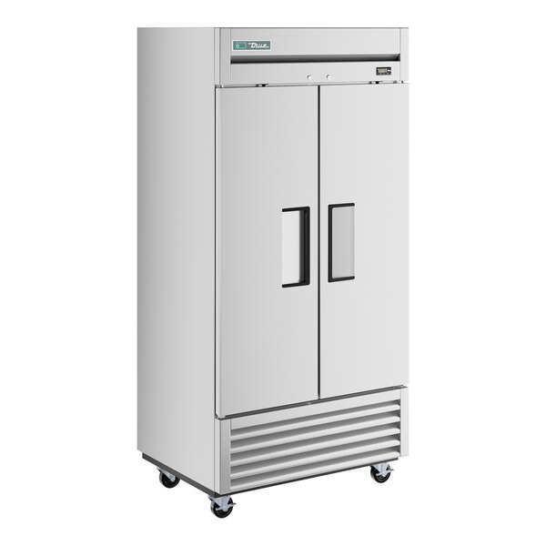 A stainless steel True reach-in freezer with black handles.