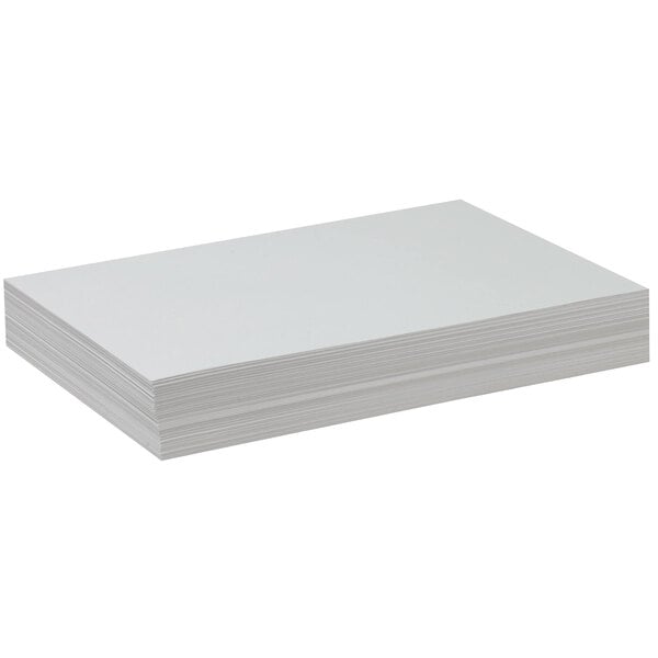 A stack of white Pacon drawing paper on a white background.