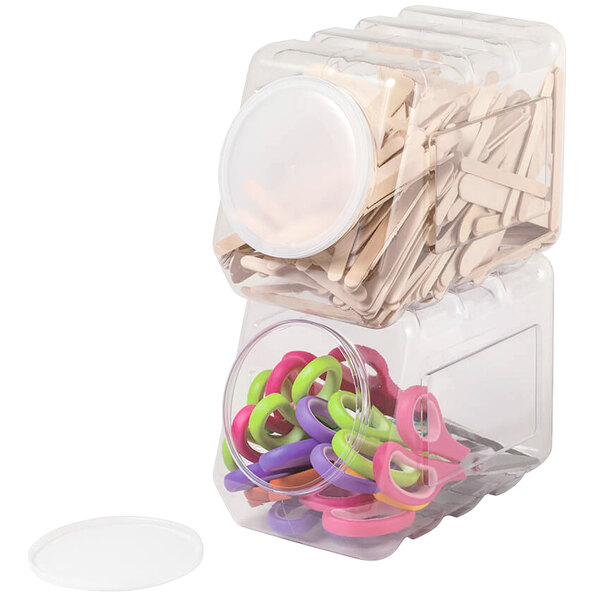 A clear plastic interlocking storage container with scissors inside.