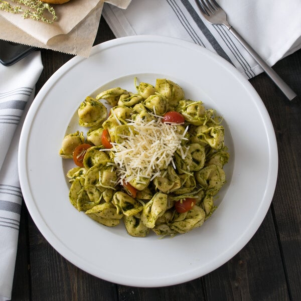 A Libbey alpine white porcelain plate with pasta, cheese, and tomatoes on it.