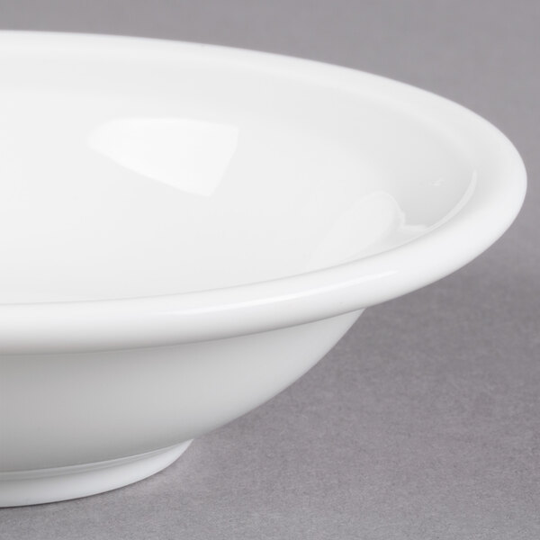A Libbey alpine white porcelain fruit bowl with a rim.