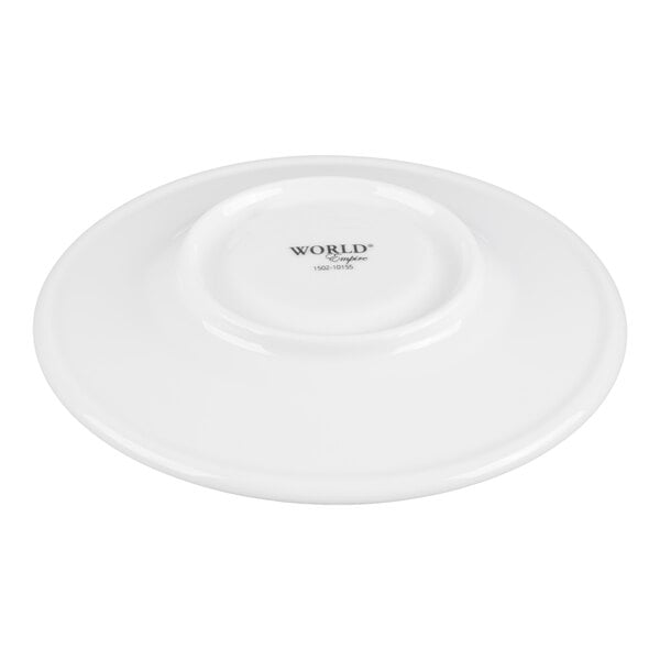 A white porcelain saucer with a slightly raised center and the word 'WORLD' printed in the middle.