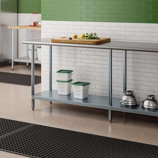 An Advance Tabco stainless steel work table with a galvanized undershelf in a kitchen.