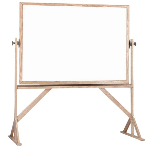 A white board with a wooden frame on a stand.