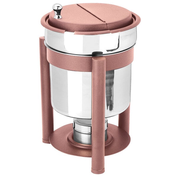 An Eastern Tabletop stainless steel soup marmite with copper accents on a table with a fuel holder.