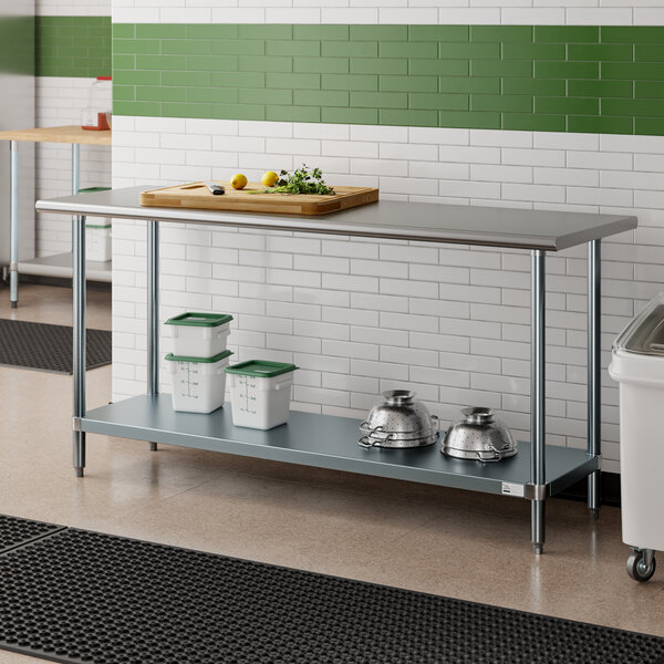 An Advance Tabco stainless steel work table with a galvanized undershelf in a kitchen.