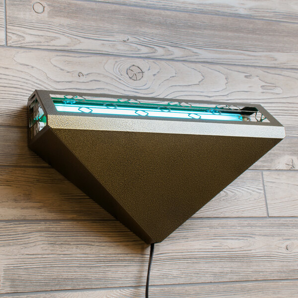 A Curtron triangular insect trap wall sconce on a wood wall.
