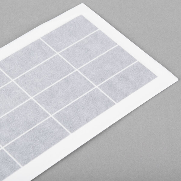 A white rectangular Curtron insect trap glue board with a grid pattern.