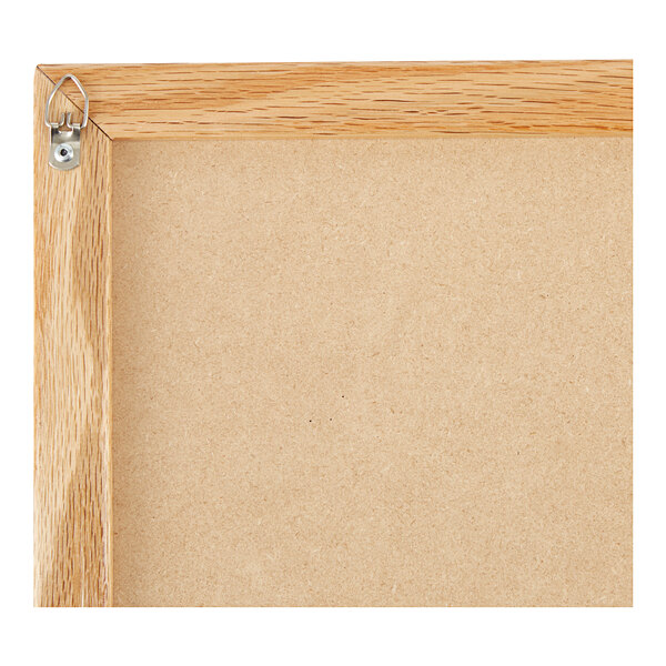 The wood frame of a black Aarco slate chalkboard.