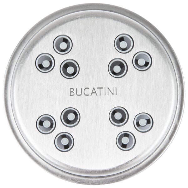 A white KitchenAid pasta press attachment with circular black accents.