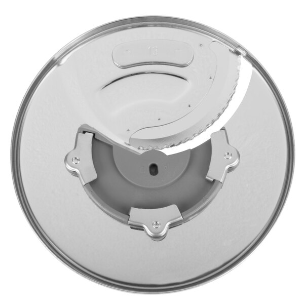 A circular silver Waring slicing disc with a circular blade in the middle.