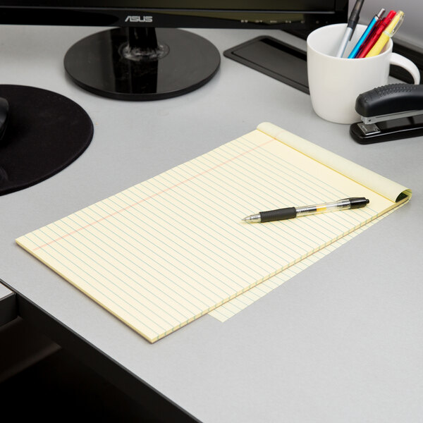 A desk with a TOPS Docket notebook and pens.