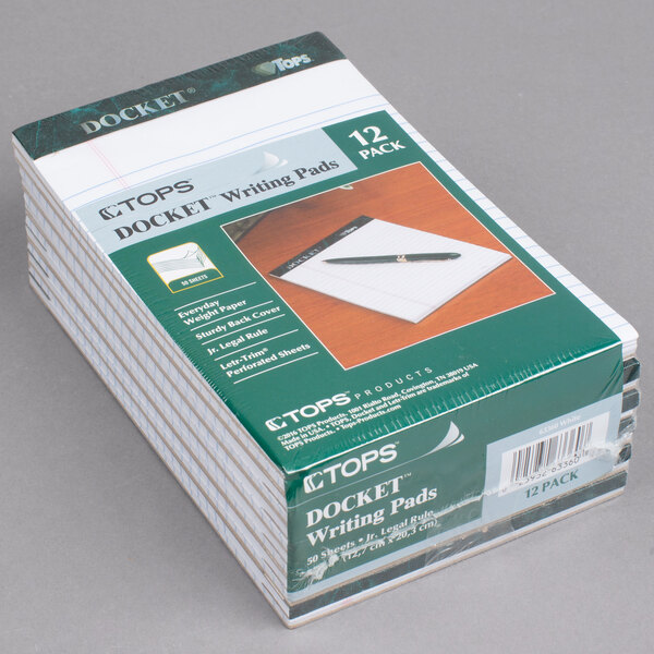 A stack of TOPS narrow ruled white writing tablets.