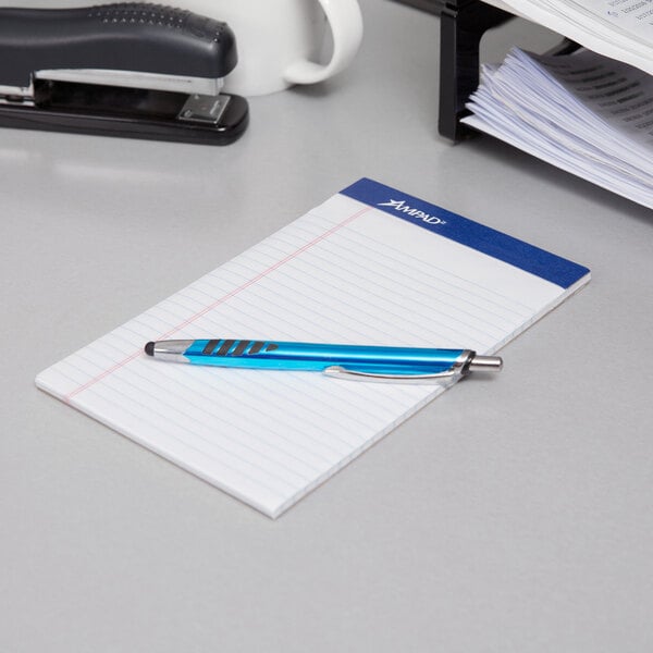 A pen on a stack of Ampad College Ruled Writing Pads