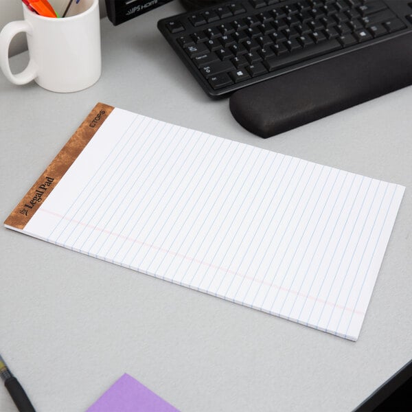 A white legal pad on a desk.