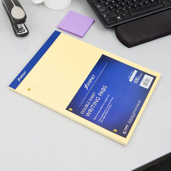 A yellow Ampad writing pad on a desk.