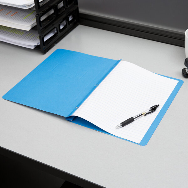 A light blue Oxford report cover with a stack of papers inside.