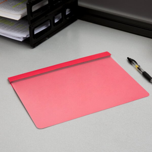 A red Oxford clear front report cover on a table with papers inside.