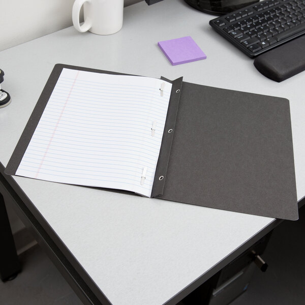 An Oxford black report cover with 3 fasteners on a notebook.