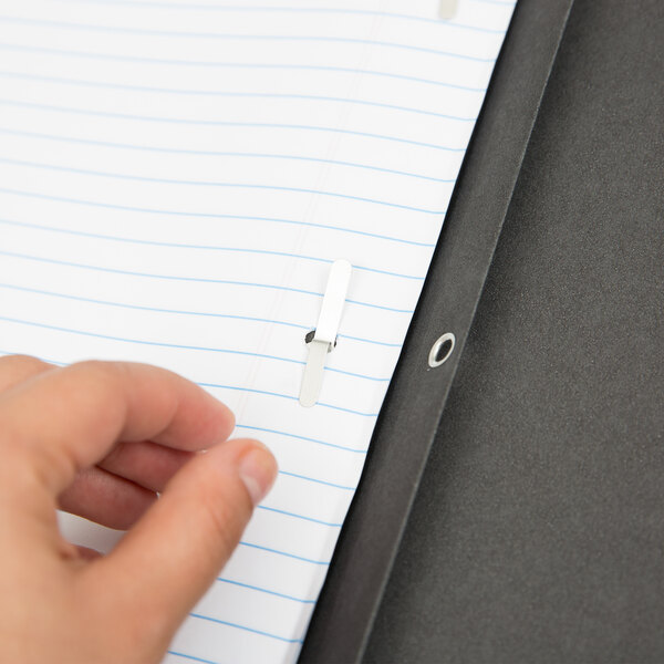 A hand using a black Oxford report cover with paper clips.