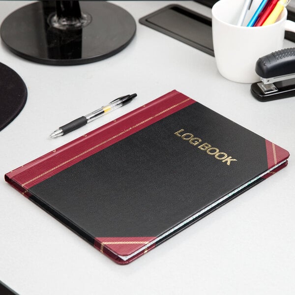 A black Boorum & Pease log book with red accents.