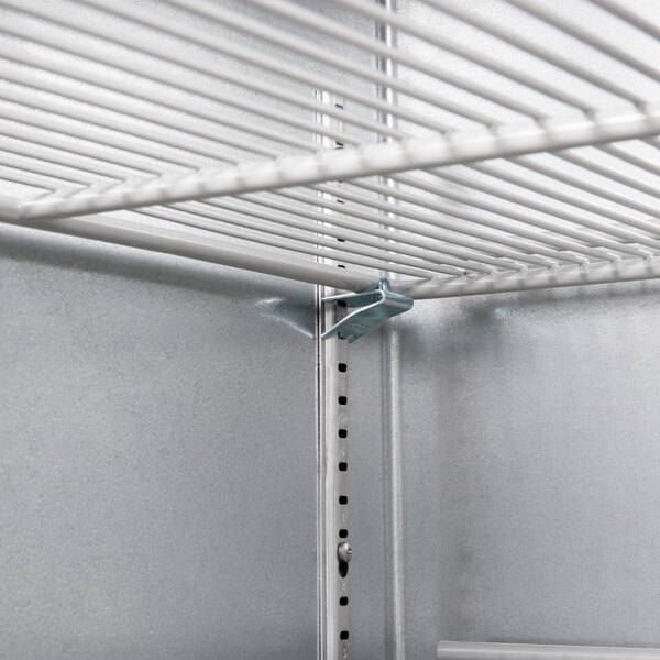 A metal shelf in a Beverage-Air back bar refrigerator.