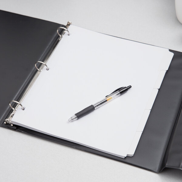 A pen in an Oxford white binder with 5 tab dividers.