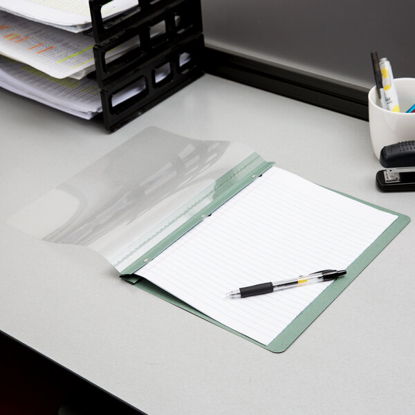 An Oxford blue clear front report cover on a stack of papers.