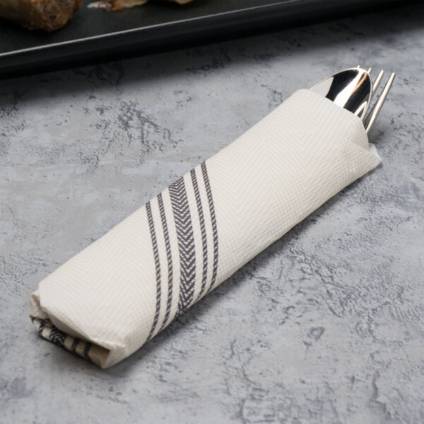 A white FashnPoint napkin with a black dishtowel print containing silverware.