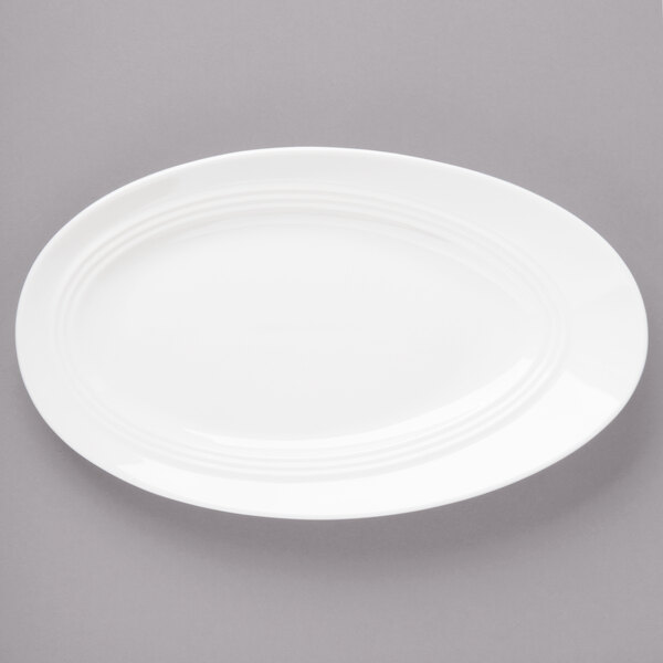 A white Bon Chef porcelain oval plate with a curved edge.
