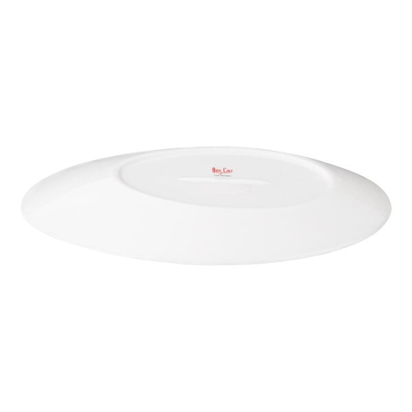 A white, oval-shaped porcelain plate shown from the bottom side.