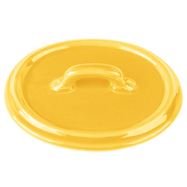 A yellow Bon Chef porcelain oval lid with a handle.
