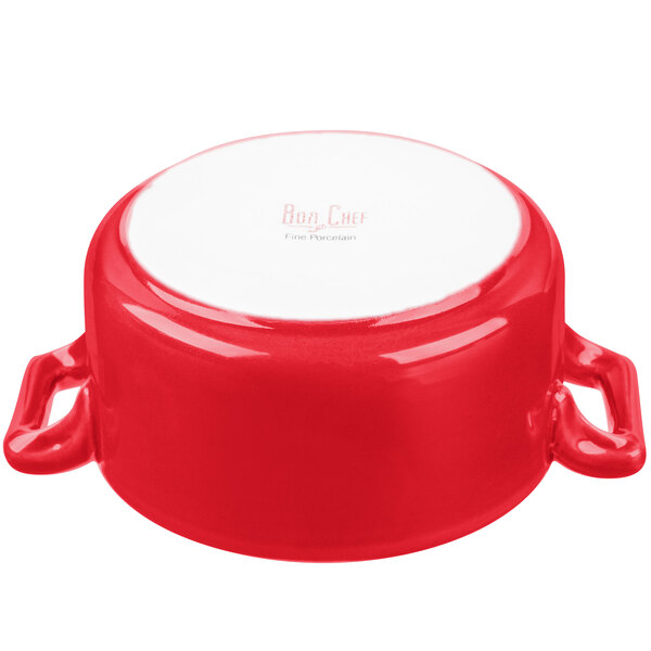 A red porcelain Bon Chef cocotte with handles.