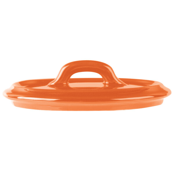 The orange porcelain lid for a Bon Chef oval cocotte with a handle.