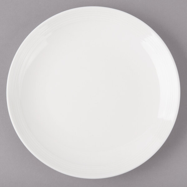 A white Bon Chef porcelain bread and butter plate with a rim.