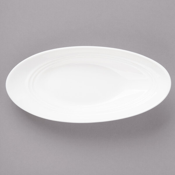 A white slanted oval porcelain bowl.
