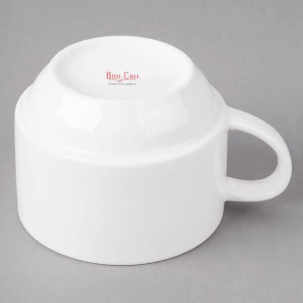 A white porcelain short cup with a handle.