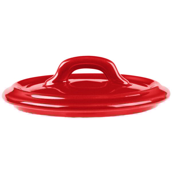A close-up of a red Bon Chef porcelain cocotte lid with a handle.