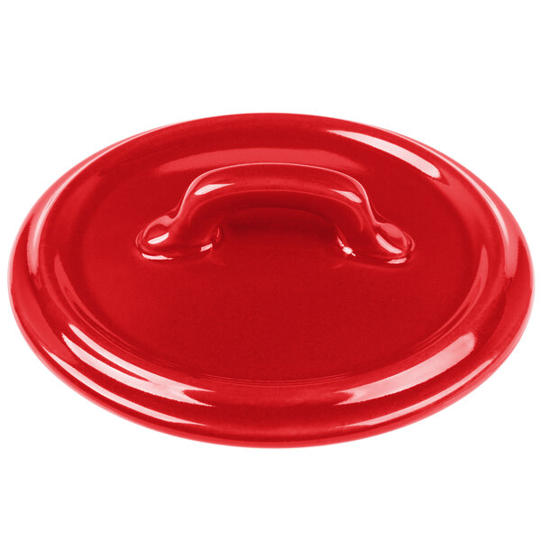 A red Bon Chef porcelain lid with a handle.