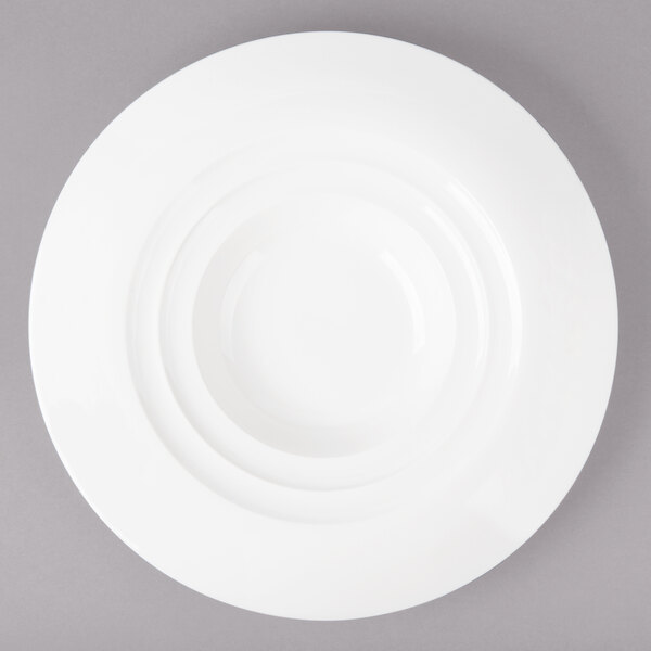 A white porcelain bowl with a circular pattern on the rim.