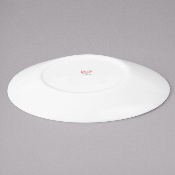 A white Bon Chef porcelain saucer on a gray background.