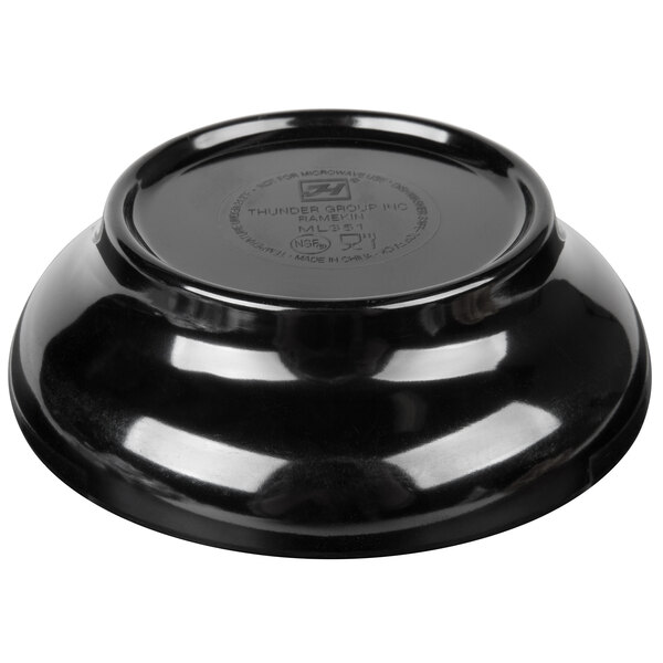 A black Thunder Group melamine salsa dish on a table.